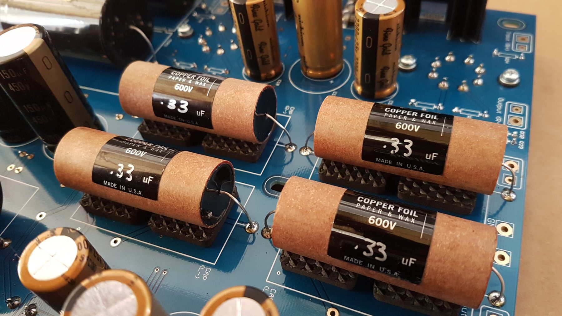 Copper foil, paper and wax output capacitors mounted on the board