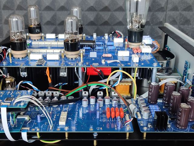 Inside a silver build: output board above, supplies below